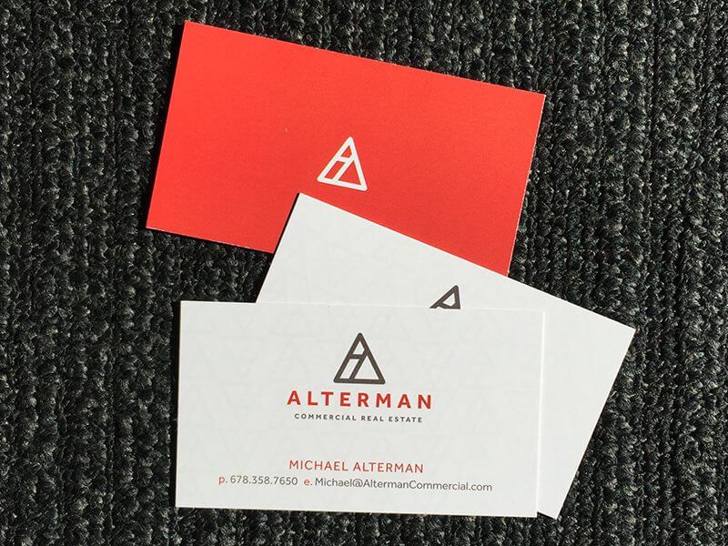 two business cards sitting on top of each other.