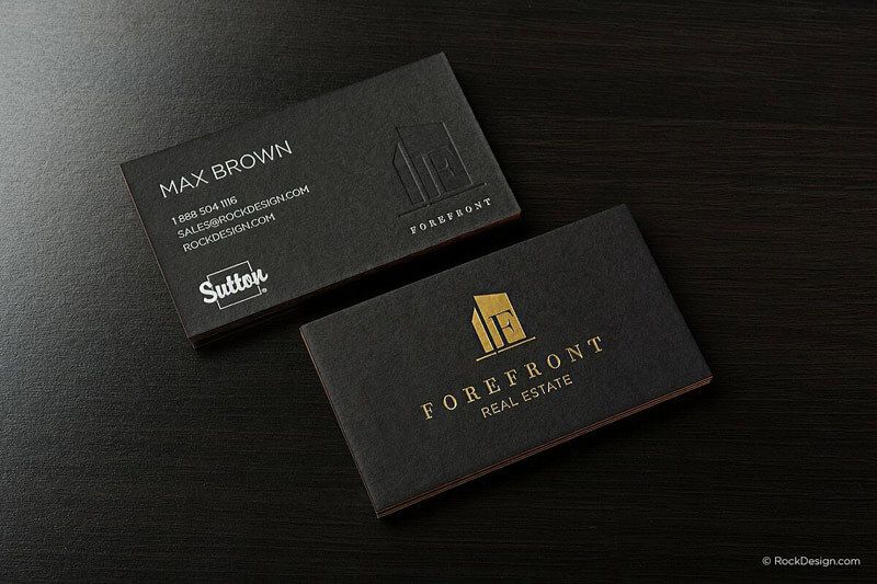 two business cards sitting on top of a table.