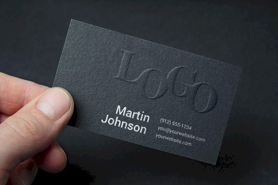 a person holding a business card in their hand.