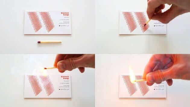 a person lighting a match with a match stick.