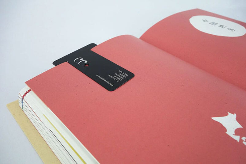 a red book with a black tag on it.