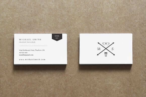 two business cards on a brown background.