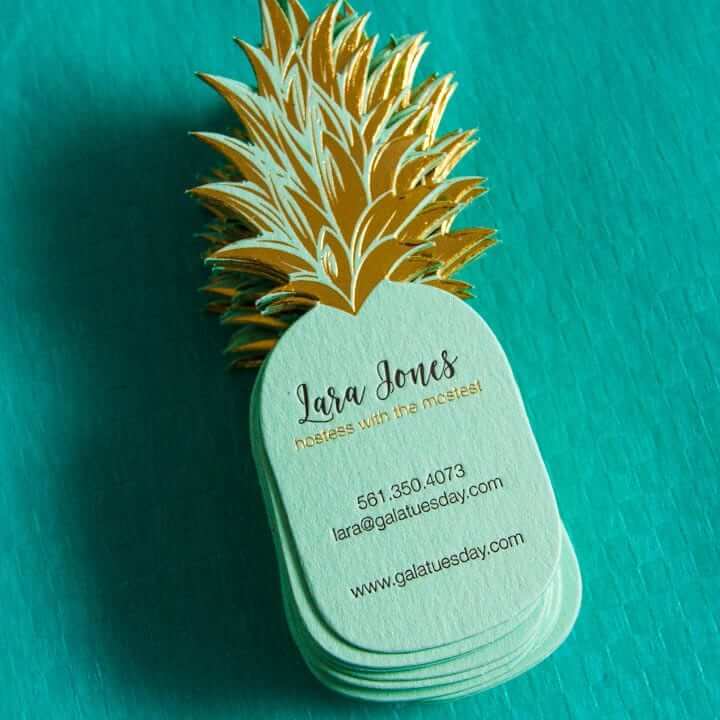 a business card with a gold pineapple on it.