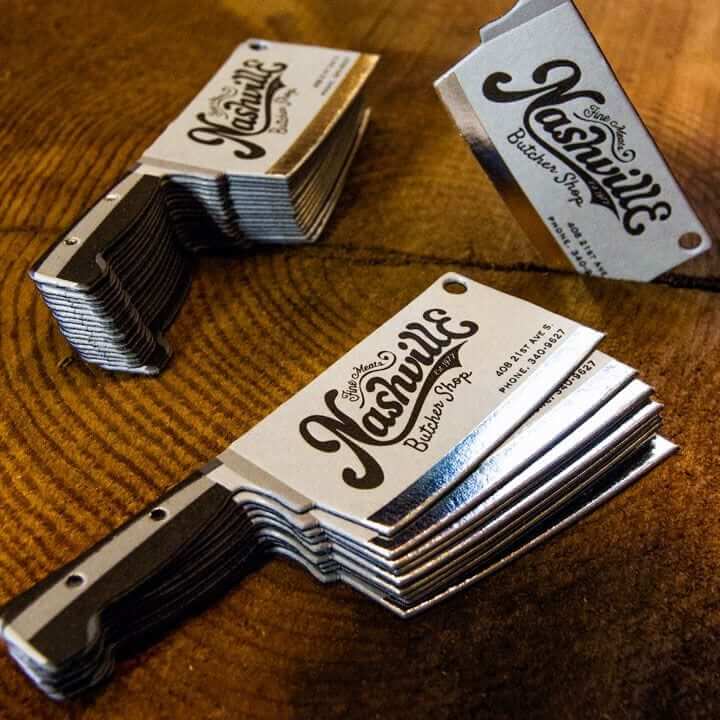 a stack of business cards sitting on top of a wooden table.