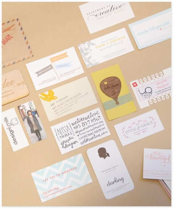 a bulletin board covered in different types of business cards.